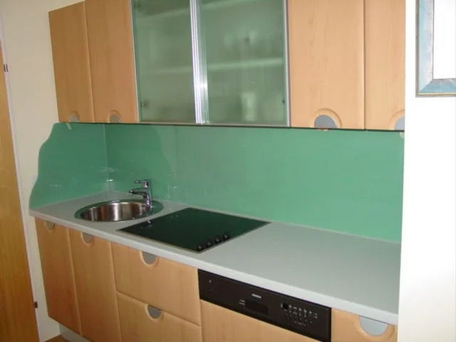 Grüne Küchenrückwand aus Glas über einer Arbeitsplatte